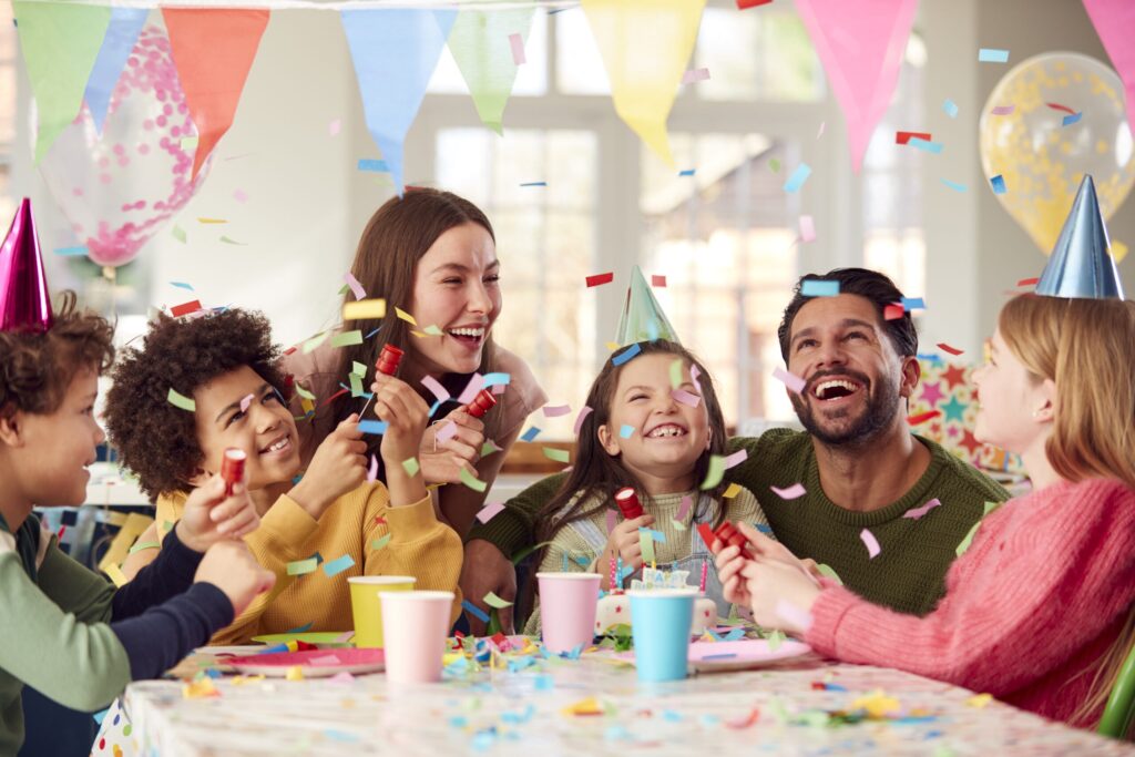 girl with parents friends home celebrating birthday firing confetti poppers party scaled 1 Water Slide Rentals